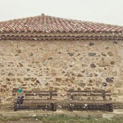 Woman standing by building