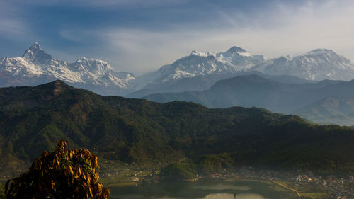 Scenic view of mountains against cloudy sky