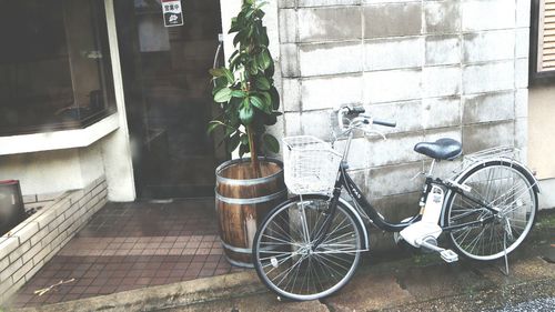 Bicycle parked against building