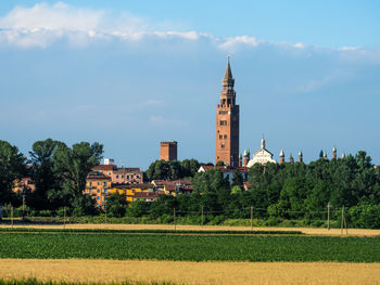 Panoramic shot of  torrazzo and fields against sky in cremona, italy