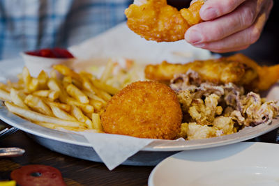 Close-up of hand holding food on table