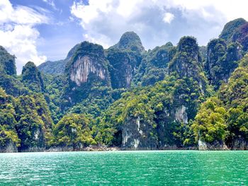 Scenic view of sea and mountains against sky
