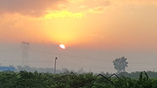 Scenic view of field against sky during sunset