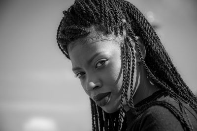 Side view portrait of confident woman with dreadlocks