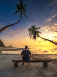 Rear view of man looking at swimming pool