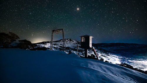 Scenic view of snow against sky at night