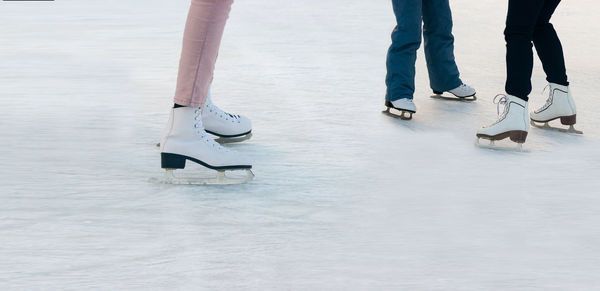 Low section of people skating on ice