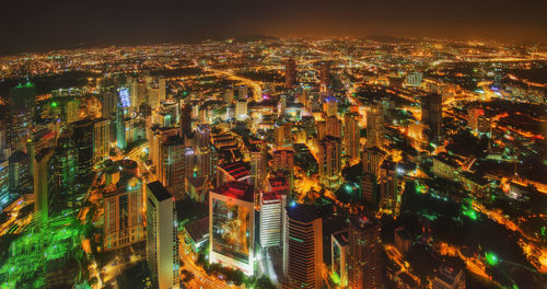 High angle view of city lit up at night