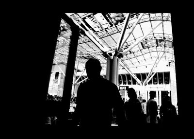 Low angle view of silhouette people standing in corridor