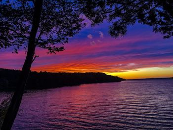 Scenic view of lake against orange sky