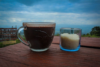 Close-up of coffee served on table against sky