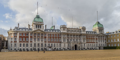 Buildings in city against cloudy sky in london