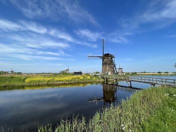 Scenic view of sea against sky windmills in holland