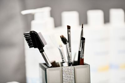 Close-up of make-up brushes in desk organizer
