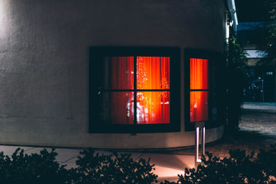 Illuminated building seen through window