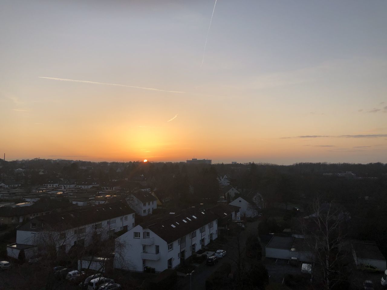 HIGH ANGLE SHOT OF TOWNSCAPE AGAINST SKY DURING SUNSET