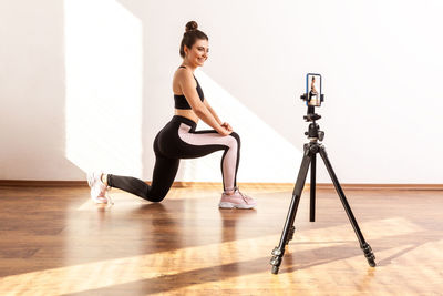 Full length of woman exercising on floor