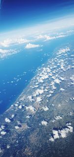 Aerial view of snowcapped mountain against sky