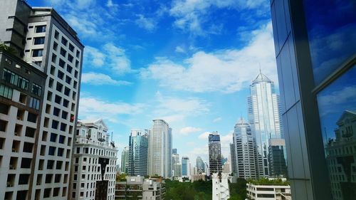 Low angle view of buildings against cloudy sky