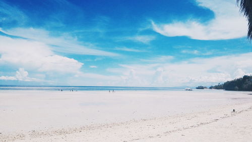 Scenic view of beach against blue sky