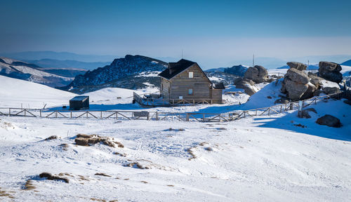 Scenic view of snowcapped mountains against blue sky