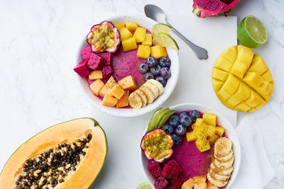 Top view dragon fruit bowl with mango and papaya