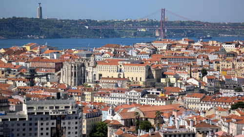 High angle view of townscape by sea against sky