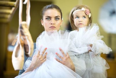 Llittle ballerina and adult ballerina in ballet class