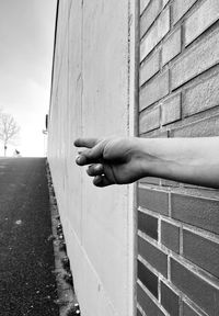 Man hand against wall