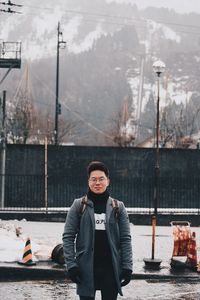 Portrait of young man standing in winter