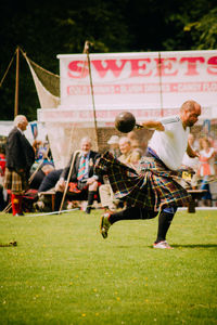 Group of people playing soccer on field