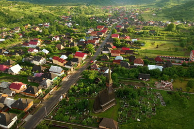 High angle view of trees and houses on field