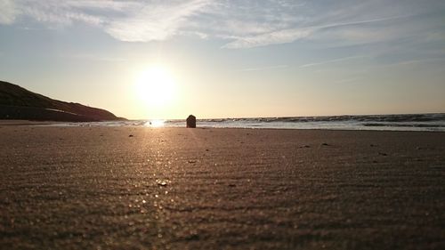 Scenic view of beach against sky during sunset