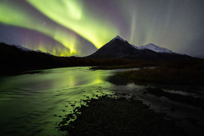 Scenic view of lake against sky at night