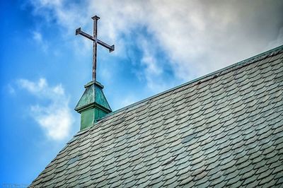 Low angle view of building against cloudy sky
