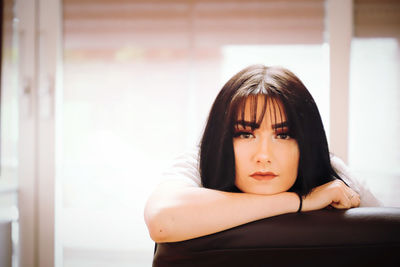 Portrait of teenage girl sitting at home