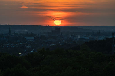 High angle view of townscape against orange sky