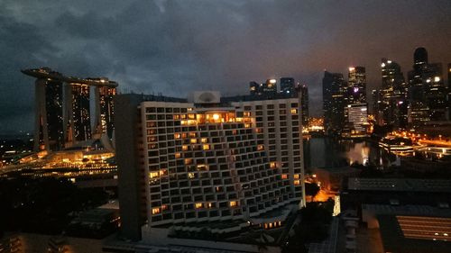 Illuminated cityscape against sky at night