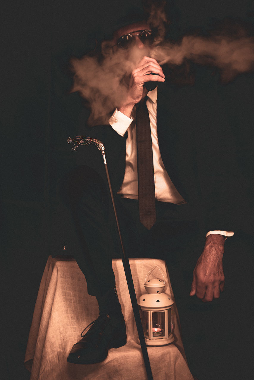 performance art, smoke, darkness, one person, adult, performing arts, guitar, performance, musician, entertainment, arts culture and entertainment, concert, stage, indoors, bowed string instrument, music, men, studio shot, holding, person, occupation, smoking, musical instrument