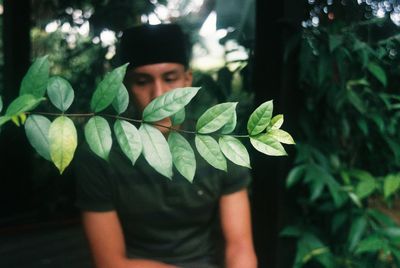 Portrait of woman holding leaves