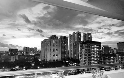 View of cityscape against cloudy sky