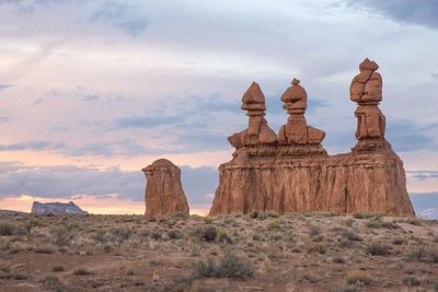 View of rock formations against cloudy sky