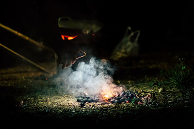 Close-up of bonfire on field at night