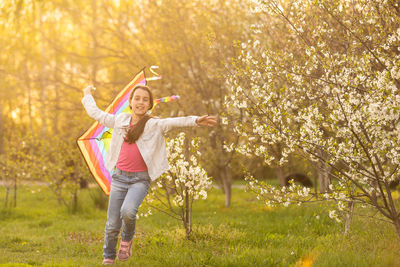 Little girl with a kite in the spring. childhood, children's day