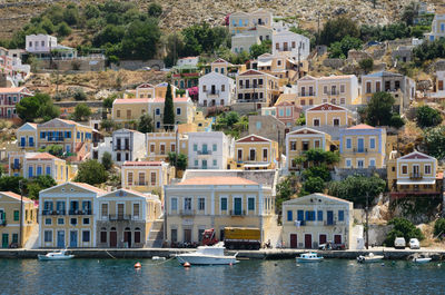 Boats in canal by buildings in town