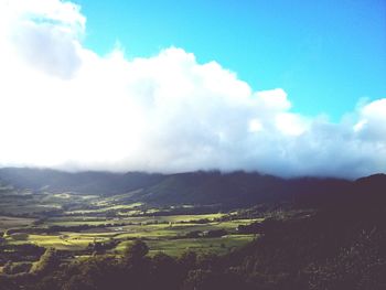 Scenic view of landscape against cloudy sky