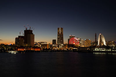 Illuminated city at waterfront