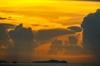 Scenic view of dramatic sky over sea during sunset