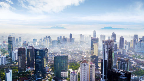 Aerial view of modern buildings in city against sky