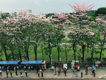 People on street in city against sky
